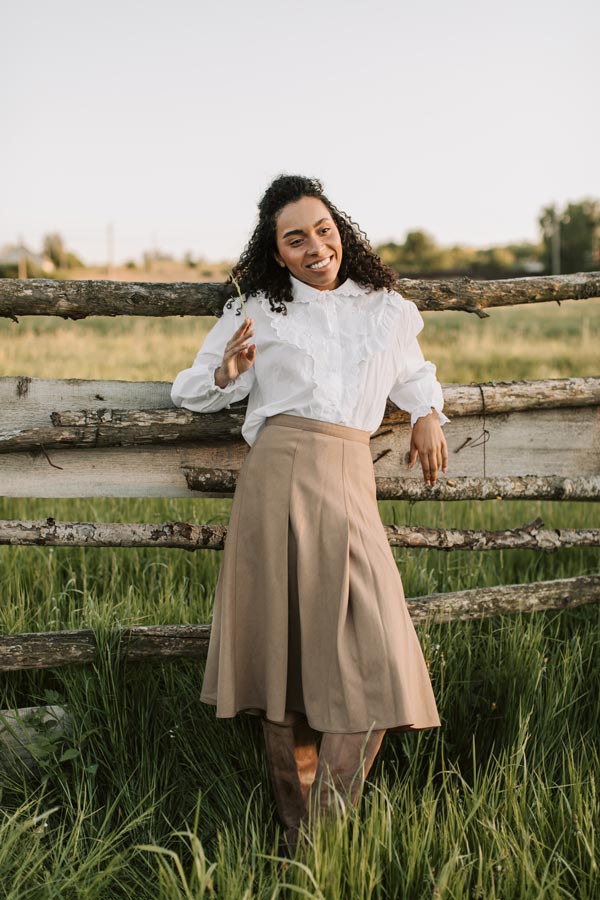 woman-entrepreneur-nature-standing-fence